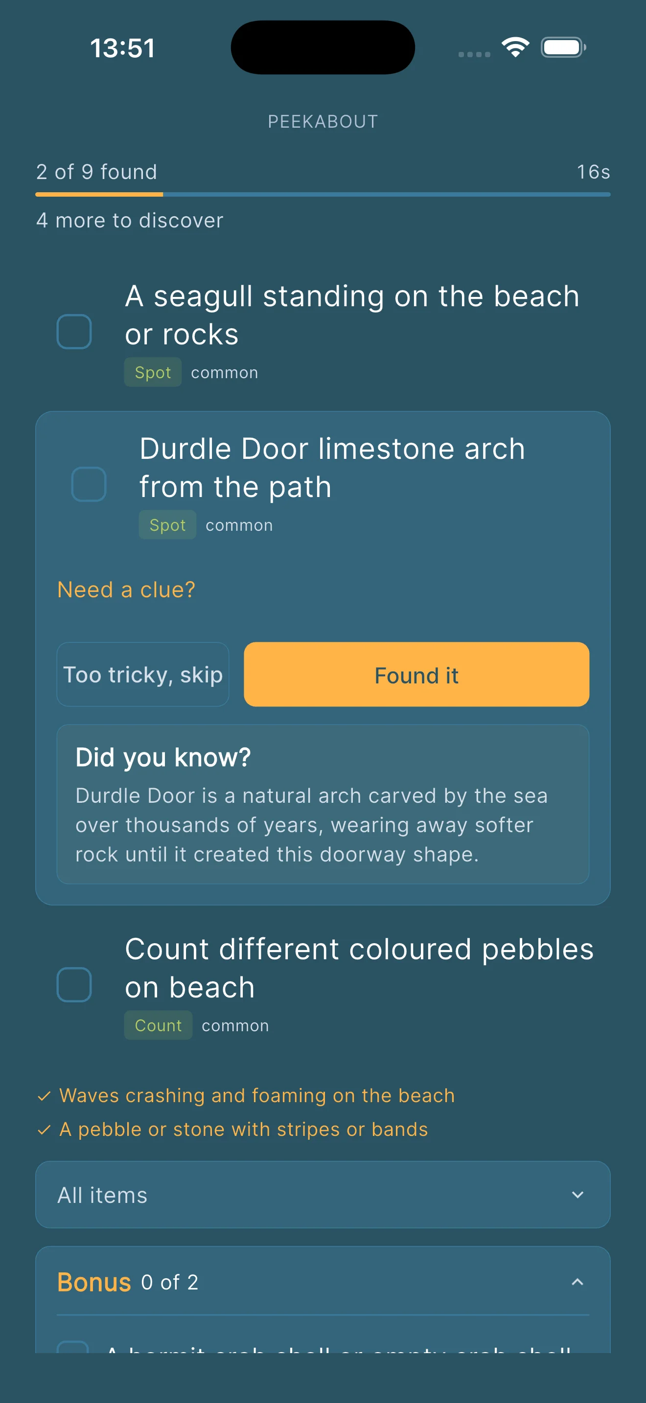 Item card for Durdle Door limestone arch from the path, a place-specific item generated from a personalised Shore hunt, with a did you know fact explaining that Durdle Door is a natural arch carved by the sea over thousands of years, wearing away softer rock until it created the doorway shape